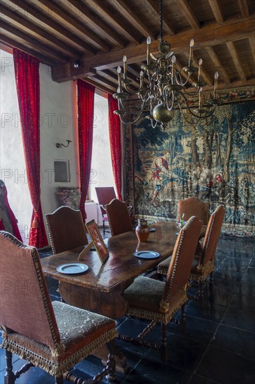 Kasteel van Laarne, interior showing antique dining room and tapestry inside 14th century medieval moated castle, East Flanders, Belgium, Europe