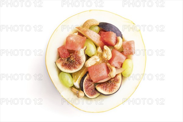 Vegetarian fruit salad of watermelon, grapes, figs, pear, orange, cashew isolated on white background. Top view, flat lay, close up