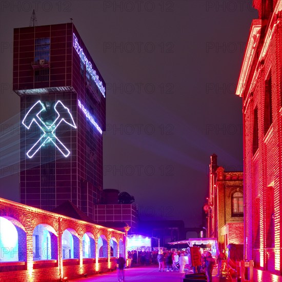 Illuminated hammerhead tower of Heinrich Robert colliery for the Extra Shift, Ost colliery, Hamm, Ruhr area, North Rhine-Westphalia, Germany, Europe