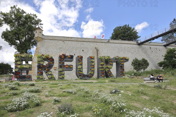 Lettering Erfurt with planting, greening, vertical garden, nature, green, bastion, two people sitting on park bench, guardhouse, guardhouse, citadel, Petersberg, Erfurt, Thuringia, Germany, Europe