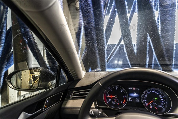 Car in an automatic car wash, car wash tunnel, drying, with hot air and rotating textile cloths