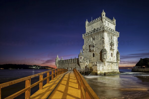 Belem Tower or Tower of St Vincent, famous tourist landmark of Lisboa and tourism attraction, on the bank of the Tagus River (Tejo) after sunset in dusk twilight with dramatic sky. Lisbon, Portugal, Europe