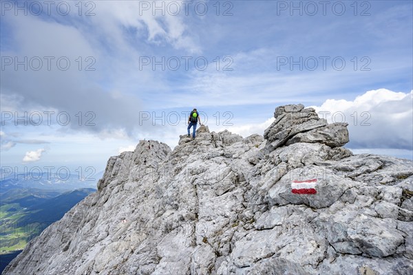 Mountaineer on a narrow rocky ridge, Watzmann crossing to Watzmann Mittelspitze, view of mountain panorama, Berchtesgaden National Park, Berchtesgaden Alps, Bavaria, Germany, Europe