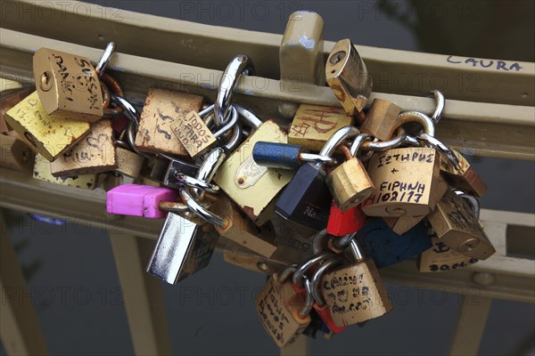 Lover's lock on a railing, love lock is a padlock which, according to custom, is attached to bridges by lovers to symbolically seal their eternal love, Prague, Czech Republic, Europe