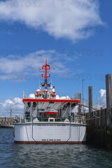 DGzRS rescue cruiser Hermann Marwede with dinghy in the harbour, stern view, Helgoland island, blue sky, North Sea, Pinneberg district, Schleswig-Holstein, Germany, Europe