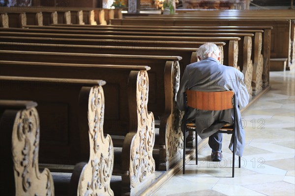 Old grey-haired man as the only churchgoer, interior of the Cistercian Abbey Church Fürstenfeld in Fürstenfeldbruck, Upper Bavaria, Bavaria, Germany, Europe