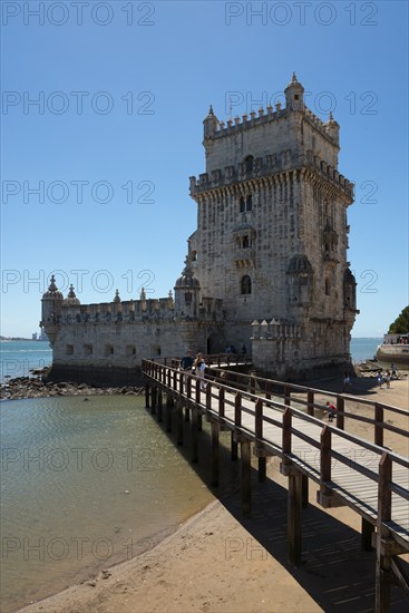 Historic stone tower with bridge over water in sunny weather, Torre de Belém, World Heritage Site, Belem, Bethlehem, Lisbon, Lisboa, River Tagus, Portugal, Europe