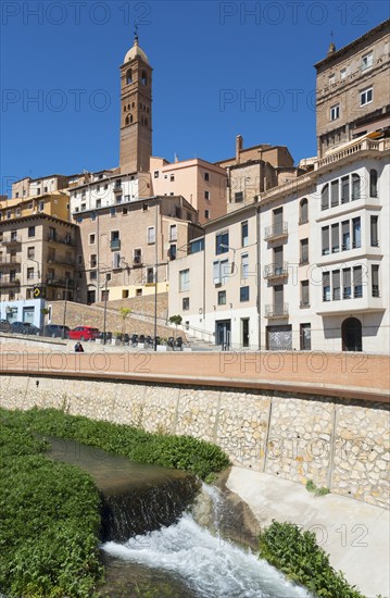 Historic town with an urban river, several buildings and a prominent tower under a clear blue sky, church, Iglesia de Santa María Magdalena, Rio Queiles, Tarazona, Zaragoza, Aragon, Spain, Europe