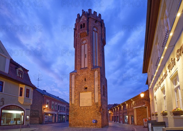 The brick Gothic Owl Tower, illuminated at night, in the old town centre of Tangermünde, Hanseatic town in the Altmark. Saxony-Anhalt, Germany, Europe