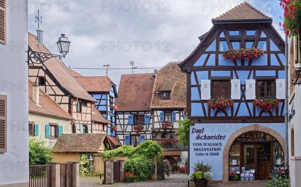 Paul Schneider winery. Well-kept half-timbered houses and floral decorations characterise the town centre of Eguisheim in Alsace. The town is classified as one of the Plus beaux villages de France. Eguisheim, Haut-Rhin, France, Europe