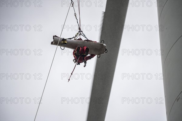 Height rescuers from the Oberhausen professional fire brigade practise abseiling from a wind turbine from a height of 150 metres, rescuing an injured person, technician, from the nacelle, Issum, North Rhine-Westphalia, Germany, Europe