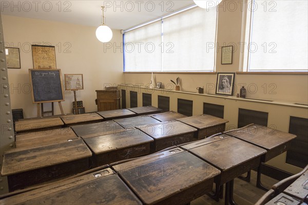 Wooden desks in school classroom from early 1900s, Radstock museum, Somerset, England, UK