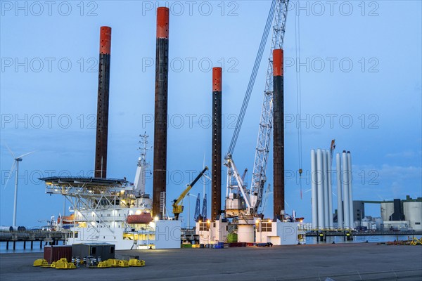 Buss-Terminal Eemshaven, logistics hub for the offshore wind farm industry, from here new wind farms in the North Sea are supplied with equipment, monopiles and transition pieces, which are anchored in the seabed and form the platform for the actual wind turbines, in the industrial harbour of Eemshaven, wind farm, Groningen, Netherlands