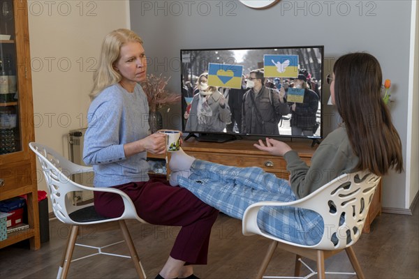 Mother and daughter, teenage, 13 years old, in a confidential conversation, at home, talking about fears, in connection with war, flight