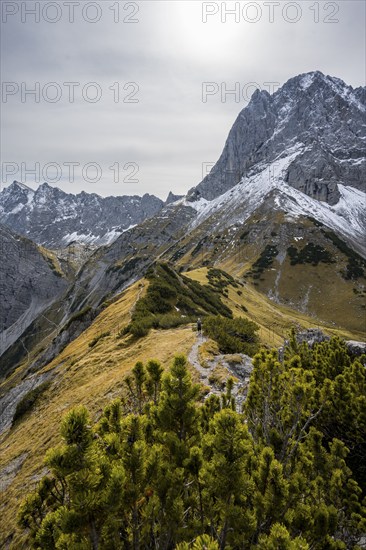 Mountaineers on a hiking trail on the ridge of Hahnkampl, mountain panorama with rocky steep peaks, view of summit Lamsenspitze, in autumn, Karwendel Mountains, Alpenpark Karwendel, Tyrol, Austria, Europe