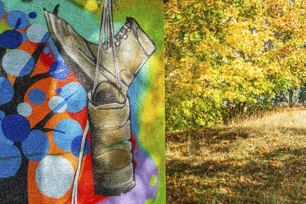 Graffito with hiking boots and trees with autumn foliage, Wiesenburg, International Art Trail, Hoher Fläming nature park Park, Brandenburg, Germany, Europe