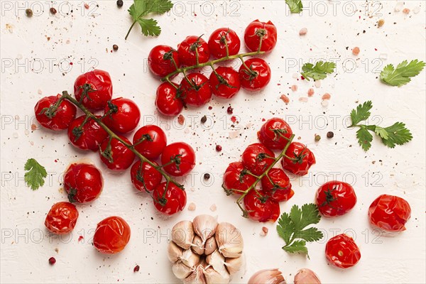 Baked branch, mini, cherry tomatoes, with spices and herbs, garlic, food background, top view, on a white background