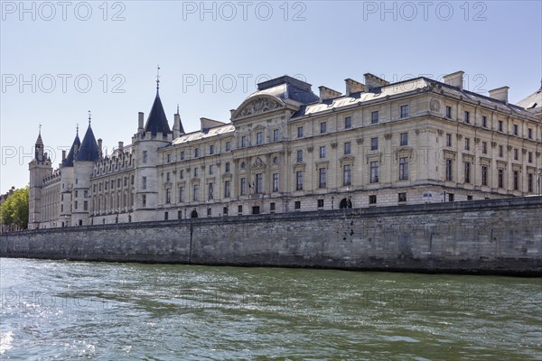 Impression of a castle on the banks of the Seine with historic architecture against a clear sky, Paris