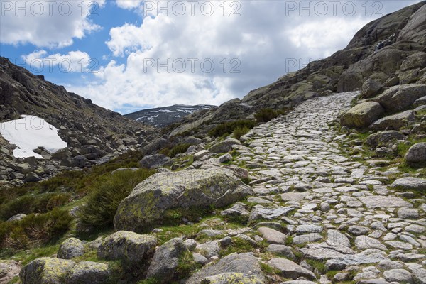 A stony hiking trail leads through a rocky mountain landscape under a partly cloudy sky, hiking area, Reserva national de Gredos, Garganta de Prado Puerte, Prado Puerte Gorge, Sierra de Gredos, Ávila, Avila, Madrid, Spain, Europe