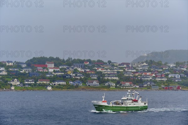 A fishing trawler at sea, in the background Alesund, Fylke, Norway, Europe