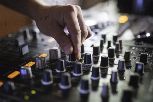 A DJ plays on a mixer and two Cdjs in Berlin, 14/08/2024