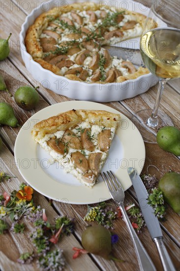 Tart with Gaishirtle and sheep's cheese, Stuttgarter Gaishirtle, pear variety, fruit, table decoration, thyme, baking, typical Swabian, Swabian cuisine, traditional cuisine reinterpreted, vegetarian, plate, cutlery, knife, fork, food photography, studio, Germany, Europe