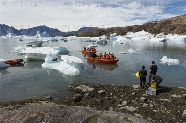 Motorboats on their way through icebergs to the Austrian polar station or polar research station Sermilik, Ammassalik Island, East Greenland, Greenland, North America