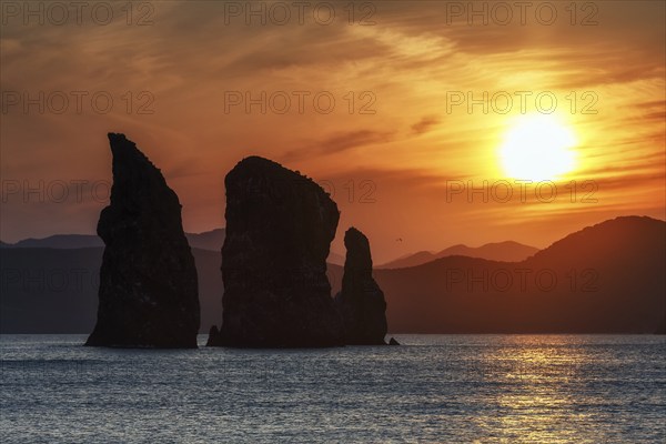 Kamchatka seascape: beautiful view of Three Brothers Rocks in Avachinskaya Bay (Pacific Ocean) at sunset. Kamchatka Peninsula, Russian Far East, Eurasia