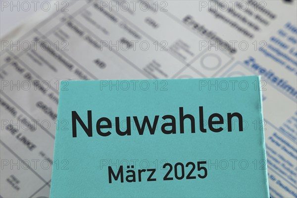 Symbolic image of new elections in Germany: Paper with the inscription NEUWAHLEN MÄRZ 2025 in front of a ballot paper