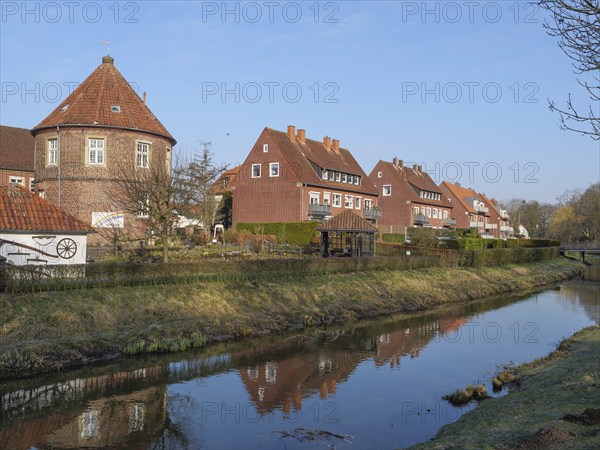 Picturesque village with brick houses along a small river with a wonderful reflection, coesfeld, münsterland, germany