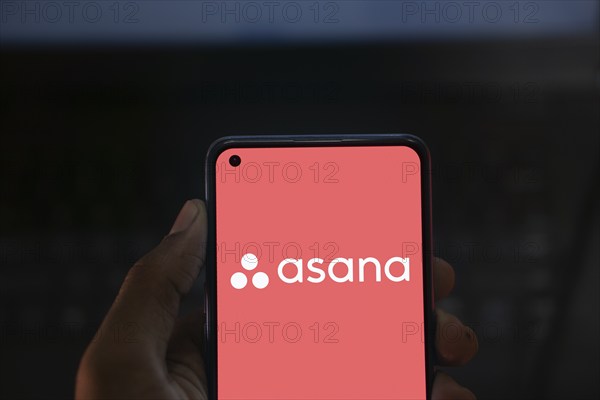 Dhaka, Bangladesh- 09 Nov 2024: Asana logo is displayed on smartphone