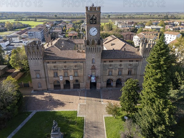 Busseto, Parma, Italy November 3rd 2024 Aerial view of palazzo orlandi torre, town hall, showcasing its clock tower and surrounding park