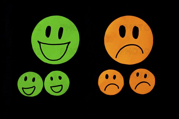 Set of smile and sadness emoticons isolated on black background. Line icons emoticons. Happy and unhappy smileys. Emoji set. Green and orange color