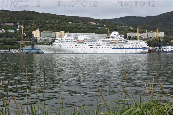 AVACHA BAY, KAMCHATKA PENINSULA, RUSSIAN FAR EAST, 4 SEPTEMBER, 2018: Evening view of white Japanese cruise liner Pacific Venus anchored at marine station in Sea Port of Petropavlovsk-Kamchatsky City