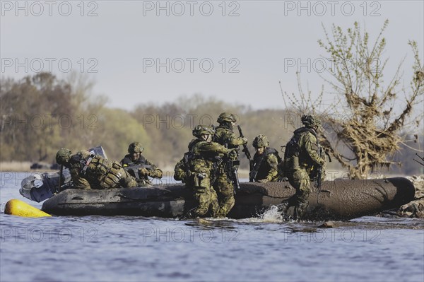 Czech and German soldiers launch an inflatable boat into the Elbe as part of the military exercise 'Wettiner Schwert' near Tangermünde, 26 March 2024. 'Wettiner Schwert' is part of the NATO Quadriga exercise