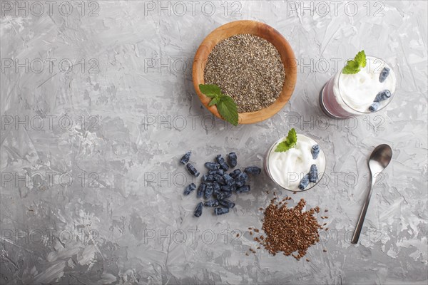 Smoothie with honeysuckle, linen and chia in a glass on gray concrete background. top view, flat lay, copy space