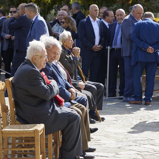 Survivors of the massacre of 3 June 1941, Elderly men in suits sit on chairs at an outdoor gathering, Visit of Federal President Frank-Walter Steinmeier to Kandanos on 31 October 2024, Federal President, Frank-Walter Steinmeier, memorial, war crimes, Nazis, Wehrmacht crimes, World War II, Kandanos, Southwest Crete, Crete, Greek Islands, Greece, Europe