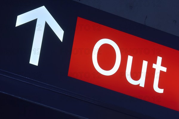 Red exit sign with white arrow pointing upwards, illuminated in a dark environment, Toronto Airport, Ontario, Canada, North America