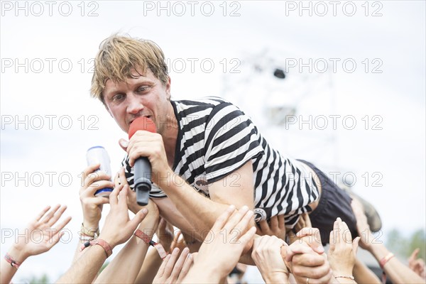 Beat Schmutz, singer of the band Schmutzki crowdsurfing on the beach in front of the Becks Beach Stage at the Highfield Festival on Saturday, Störmthaler See, 17/08/2024