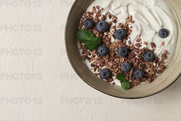 Yogurt with chocolate muesli, with berries, blueberries, breakfast, close-up, fork on top, no people