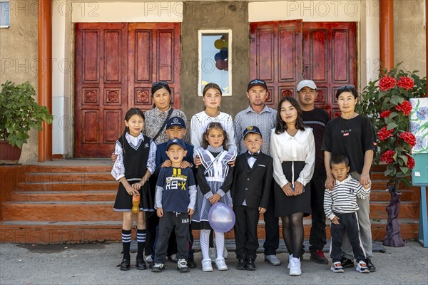 Family and school children, group posing in front of the school on the first day of school, Issyk-Kul region, Kyrgyzstan, Asia