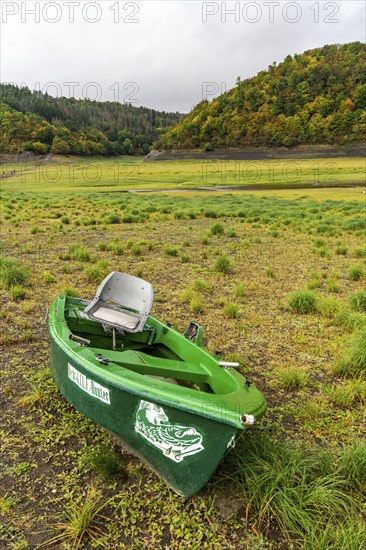 The Edersee, near Waldeck, the third largest reservoir in Germany, currently has only just under 13% of its normal level, the lake was last full in May 2022, dried up due to lack of rain, stranded fishing boat, pike hunter, the lake shore and the lake bottom is overgrown with fresh grass, Hesse, Germany, Europe