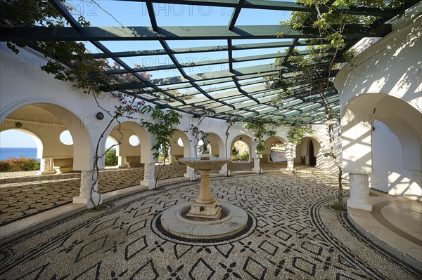 A bright, Mediterranean-inspired courtyard with cobblestones and climbing plants, overlooking the sea, thermal springs, thermal baths, thermal baths of Kallithea, Kallithea, Rhodes, Dodecanese, Greek Islands, Greece, Europe