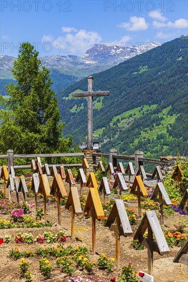 Cemetery with large wooden cross and simple grave crosses, historic village centre, Grimentz, Val d'Anniviers, Valais Alps, Canton Valais, Switzerland, Europe