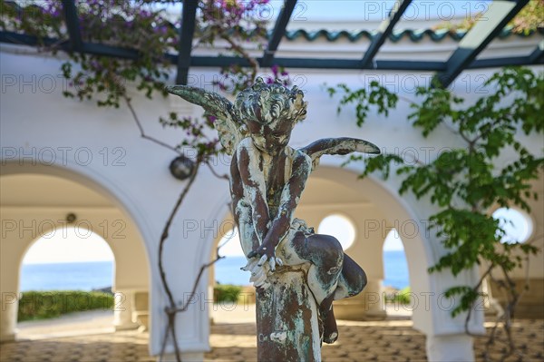 Bronze angel statue in front of arched windows overlooking the sea, decorated with plants and round arches, thermal springs, thermal baths, thermal baths of Kallithea, Kallithea, Rhodes, Dodecanese, Greek Islands, Greece, Europe