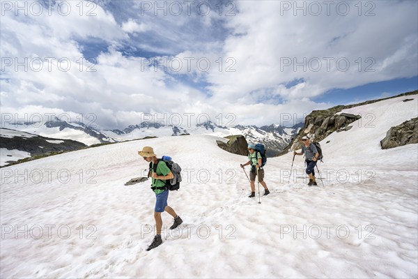 Three mountaineers crossing a snowfield, ascent to the Nördliche Mörchnerscharte, Berliner Höhenweg, Zillertal Alps, Tyrol, Austria, Europe