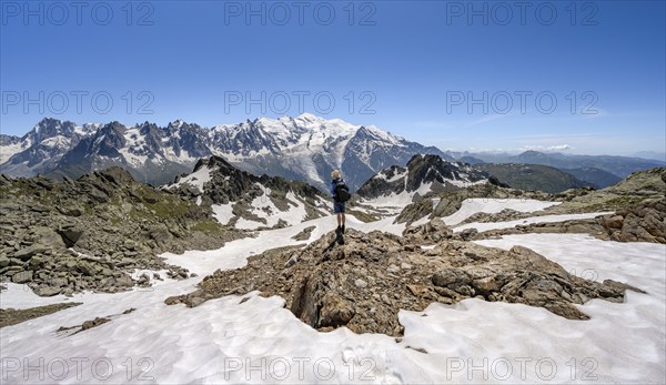 Mountaineer crossing a snowfield, mountain landscape with mountain peak Mont Blanc, Mont Blanc massif, Aiguilles Rouges, Chamonix-Mont-Blanc, Haute-Savoie, France, Europe