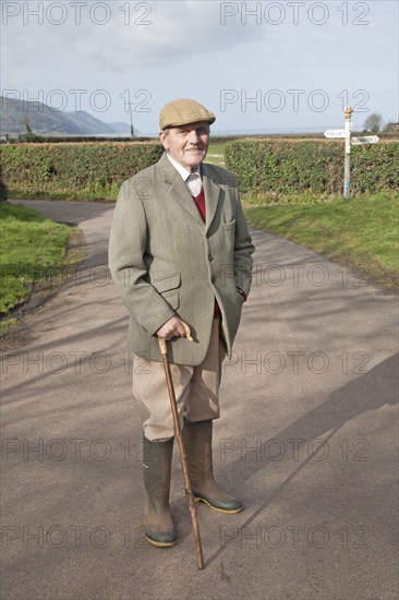 Smartly dressed gentleman out for his morning walk in Bossington, Exmoor national park, Somerset, England, United Kingdom, Europe