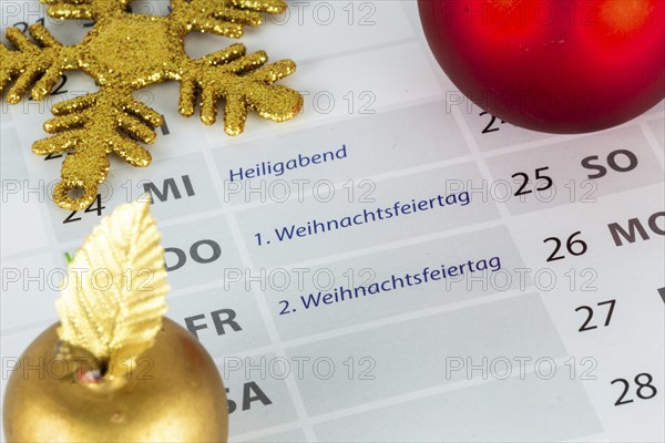 Close-up of a section of a calendar showing the 2025 Christmas holidays with Christmas decorations