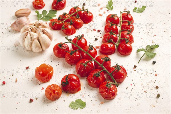 Baked branch, mini, cherry tomatoes, with spices and herbs, garlic, food background, top view, on a white background